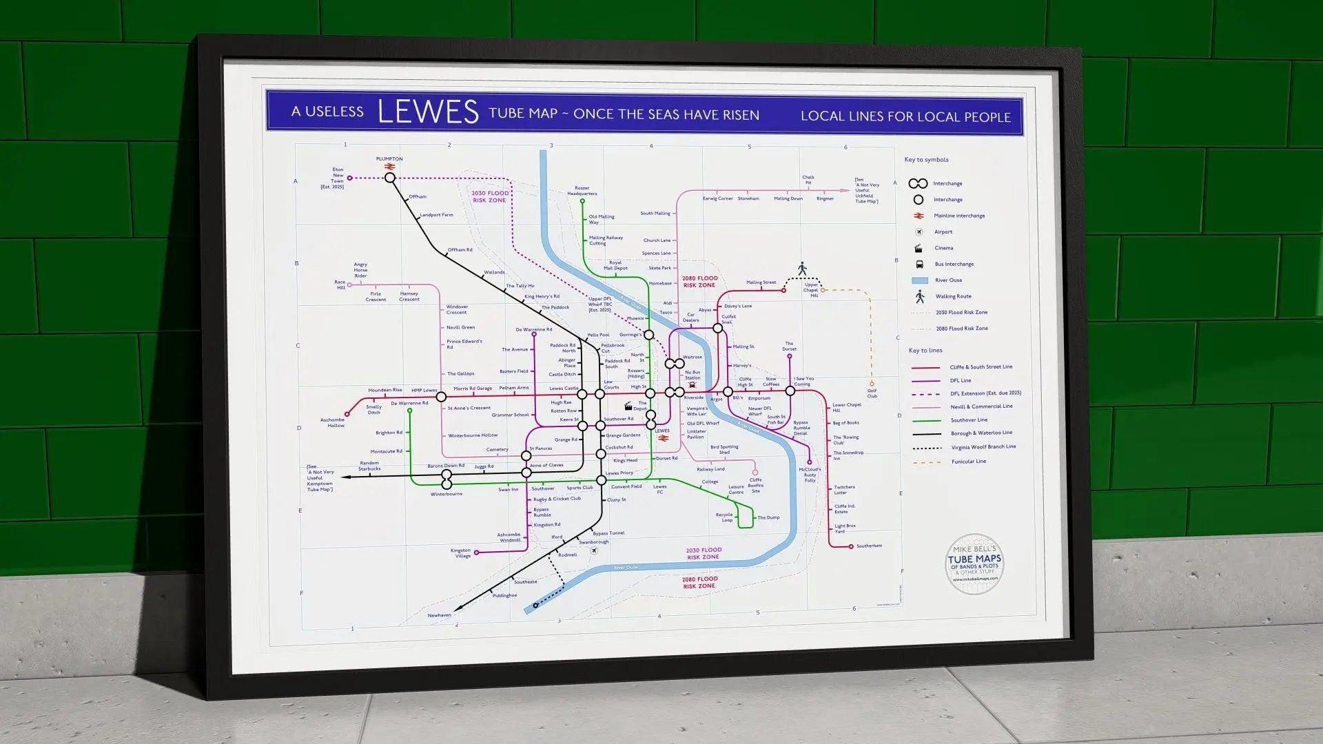Housewarming gift for Lewes locals - A1 framed Giclée Lewes Tube Map hung on a feature wall, showing the East Sussex town as a London Underground-style network of landmarks and local quirks, designed by Mike Bell at mikebellmaps.com.