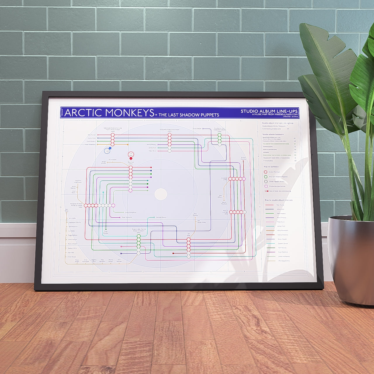 Arctic Monkeys discography tube map in A1 (594x841mm, 24x36in), framed Giclée wall art print propped against a wall on the floor, designed by Mike Bell.