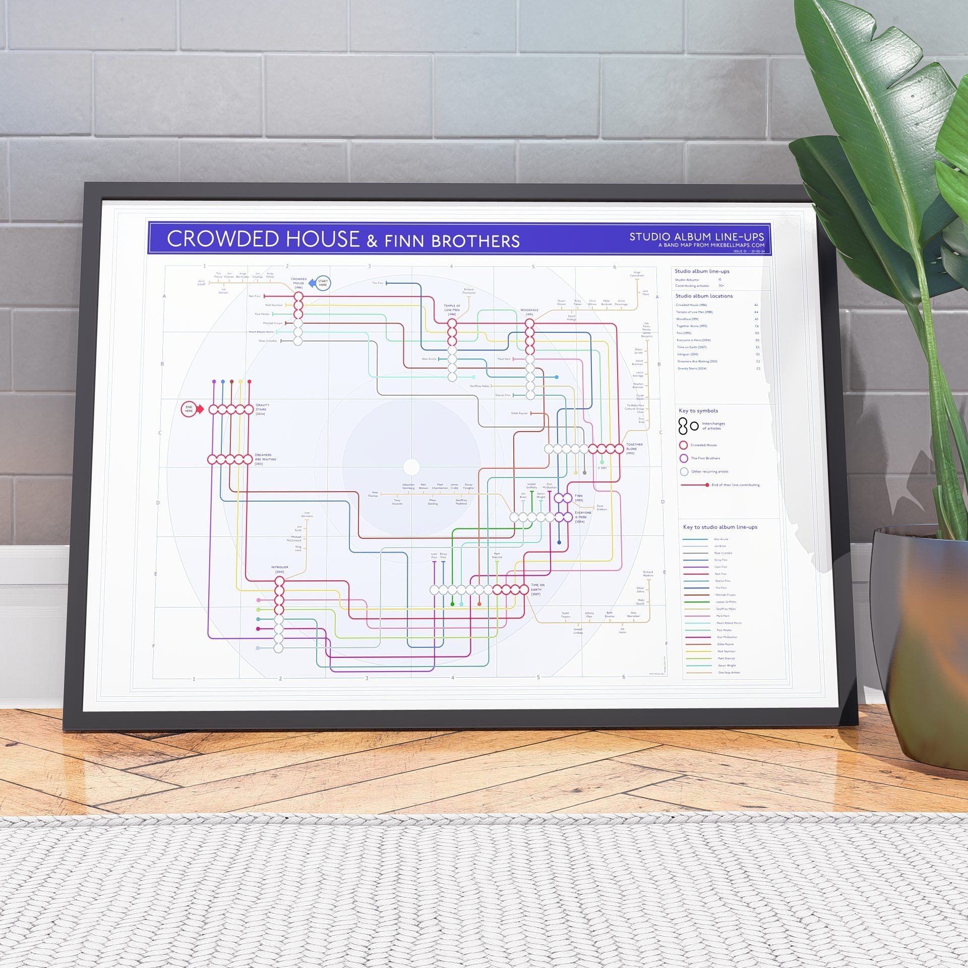 Crowded House discography tube map in A1 (594x841mm, 24x36in), framed Giclée wall art print propped against a wall on the floor, designed by Mike Bell.