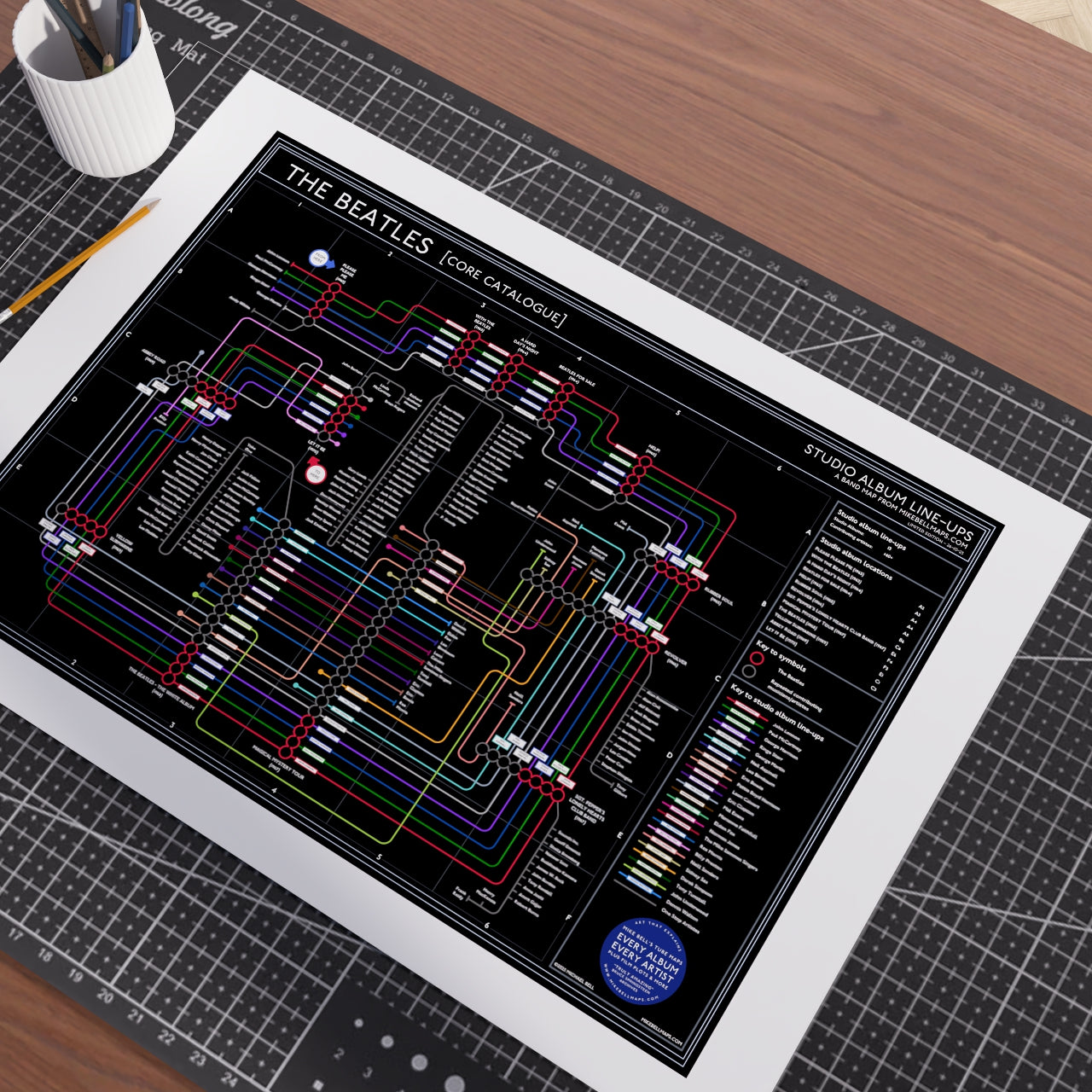 Close-up of The Beatles Black Edition discography map tracing the albums from Please Please Me in 1963 to Let It Be in 1970, designed by Mike Bell.