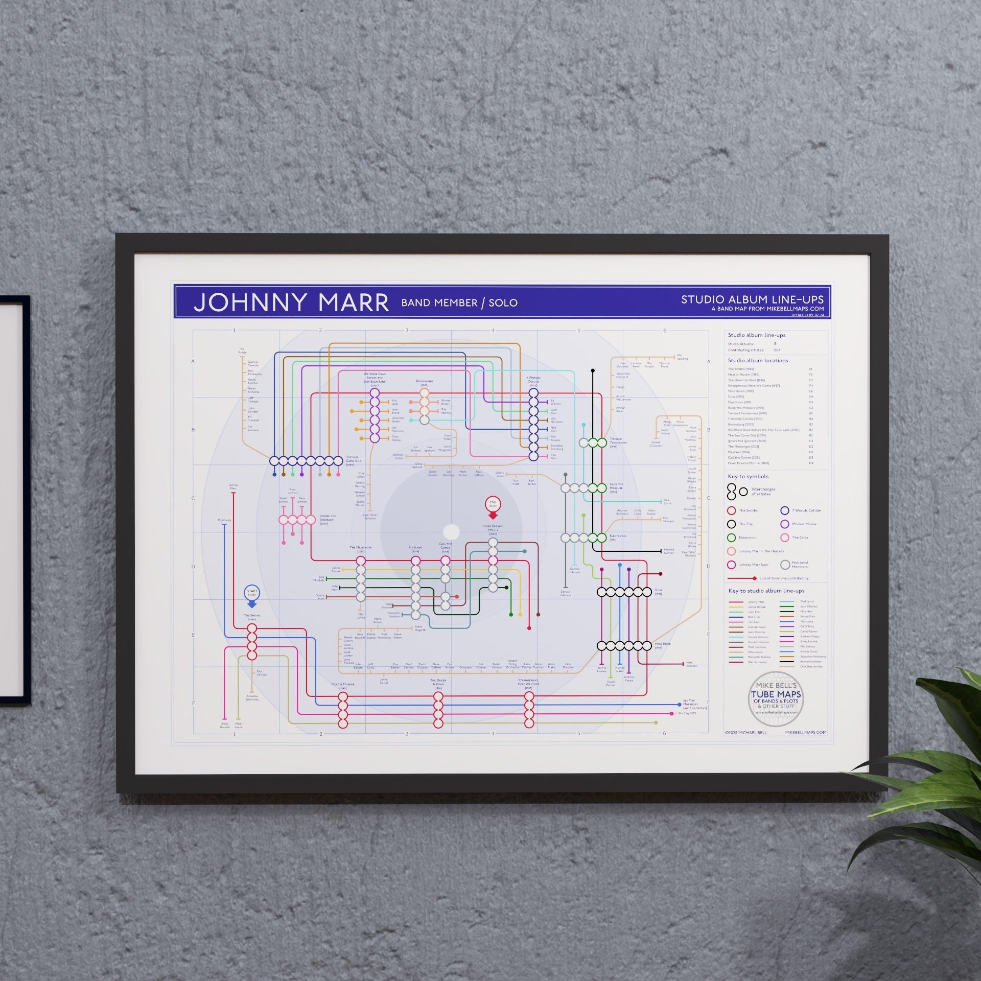 Johnny Marr discography tube map in A2, framed Giclée wall art print hung on a wall, by Mike Bell.