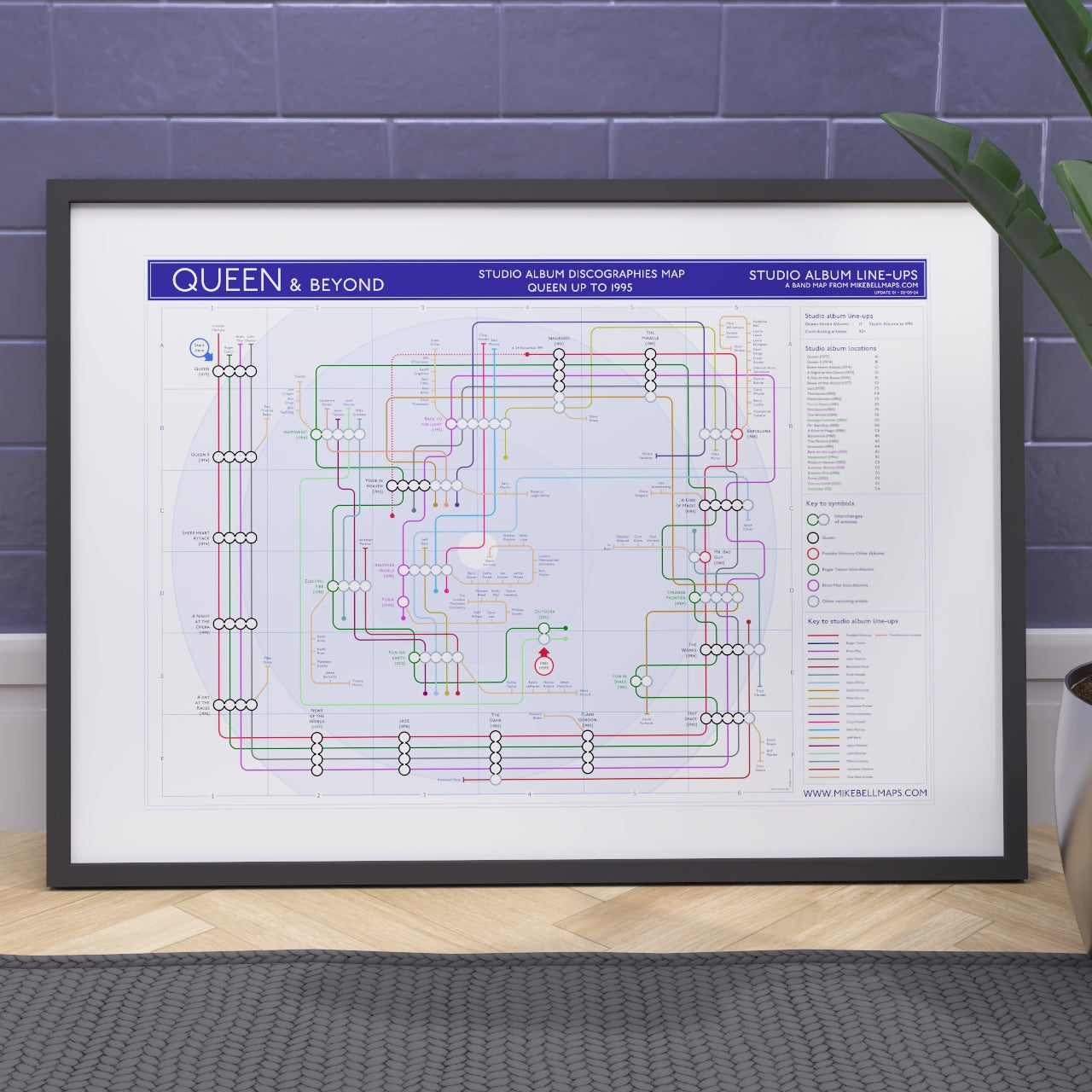 Queen discography map art print in a black A1 landscape frame, showing all 15 studio albums in order with every credited musician as a tube line, designed by Mike Bell