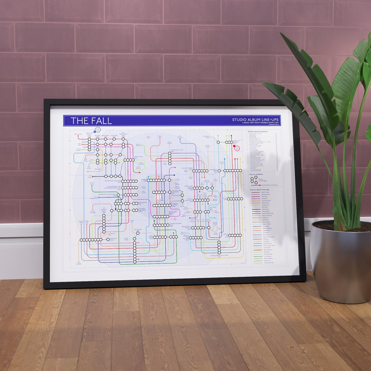The Fall discography tube map art print framed on a wall, 31 studio albums drawn as stations across 38 years with Mark E. Smith as the only unbroken line, by Mike Bell