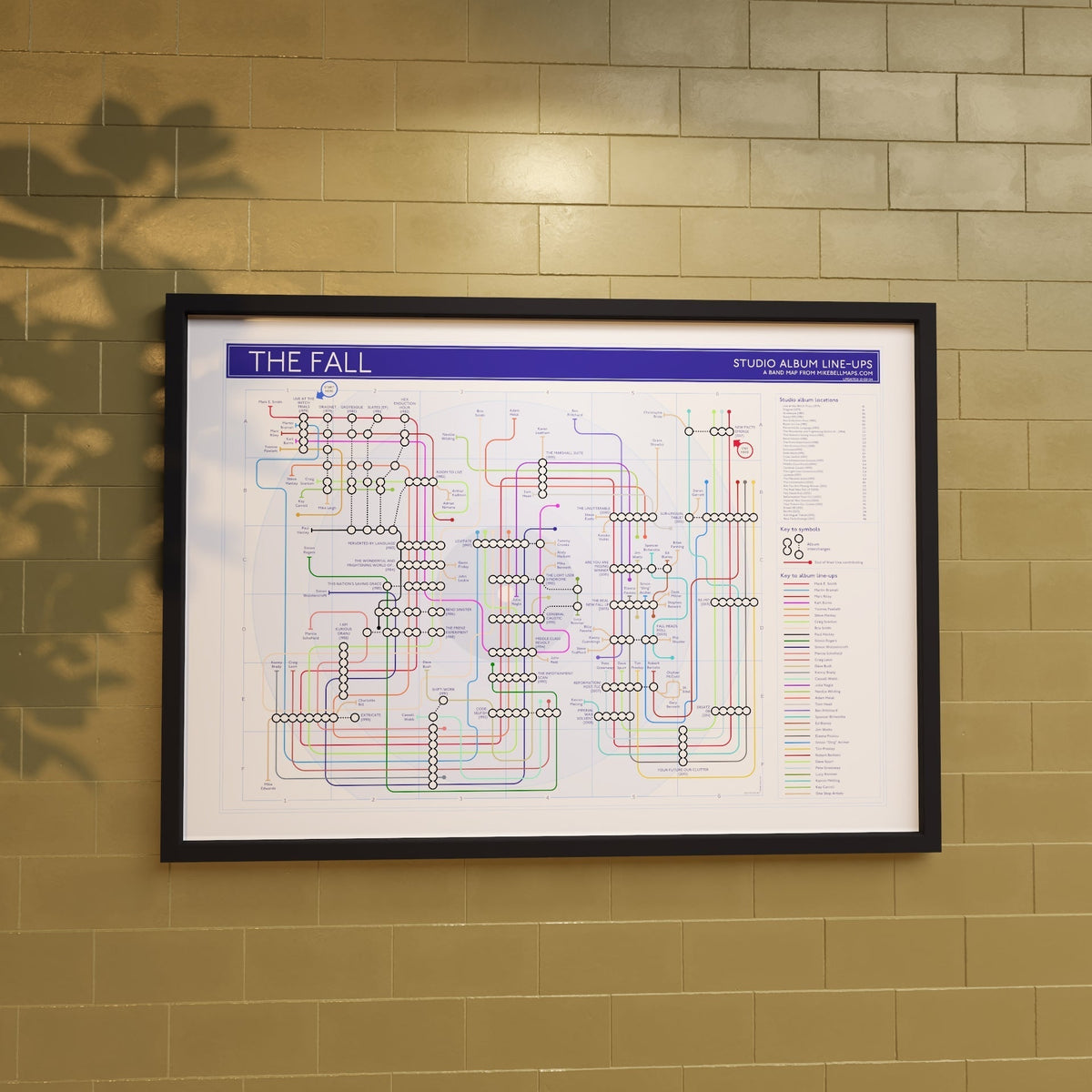 A discography tube map art print in an A1 black wood frame, showing studio albums as stations and every credited musician as a line, designed by Mike Bell at mikebellmaps.com