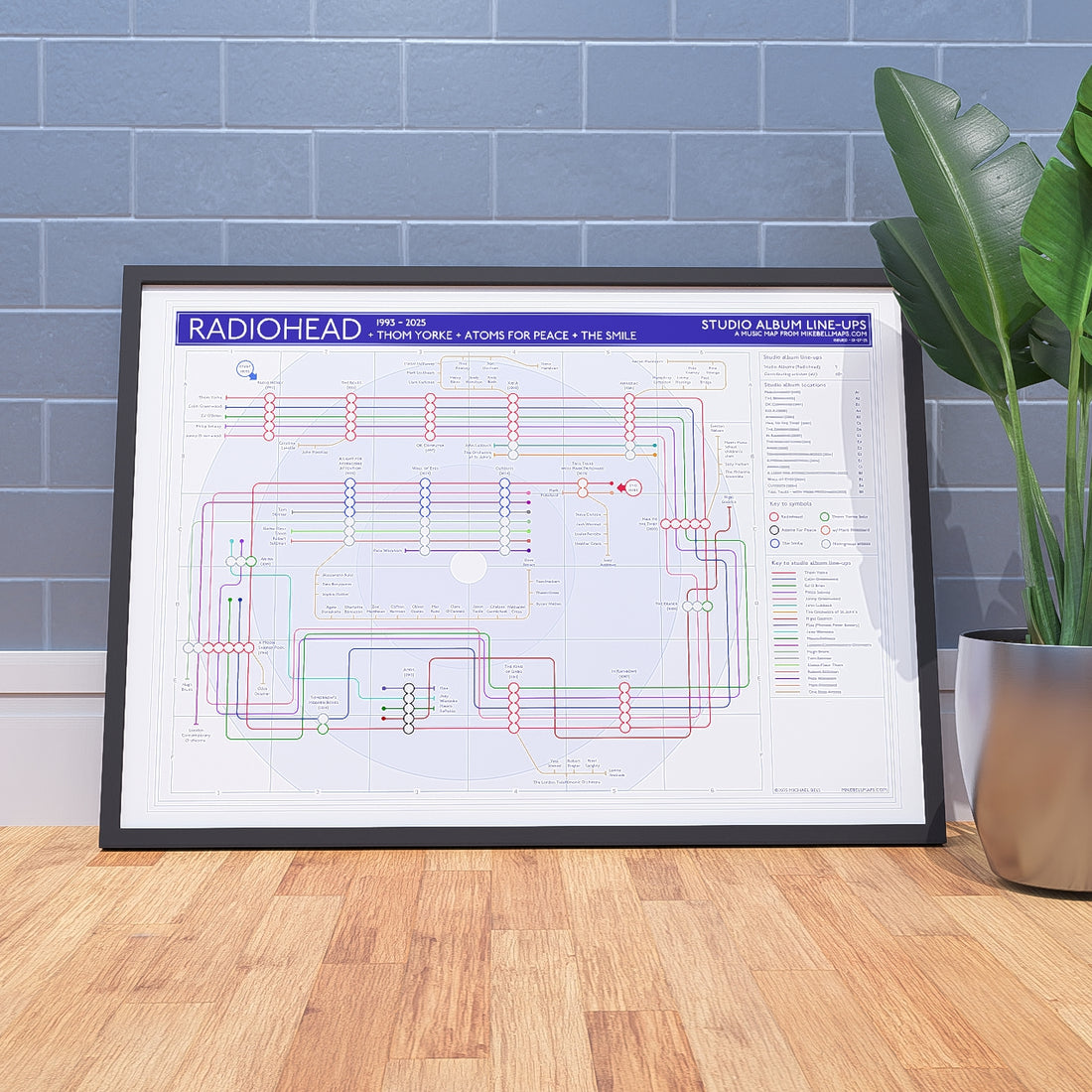 Ideal gift for Radiohead fans - A1 framed Giclée discography tube map leaning against a wall, showing every studio album in order from Pablo Honey (1993) to A Moon Shaped Pool, designed by Mike Bell at mikebellmaps.com.