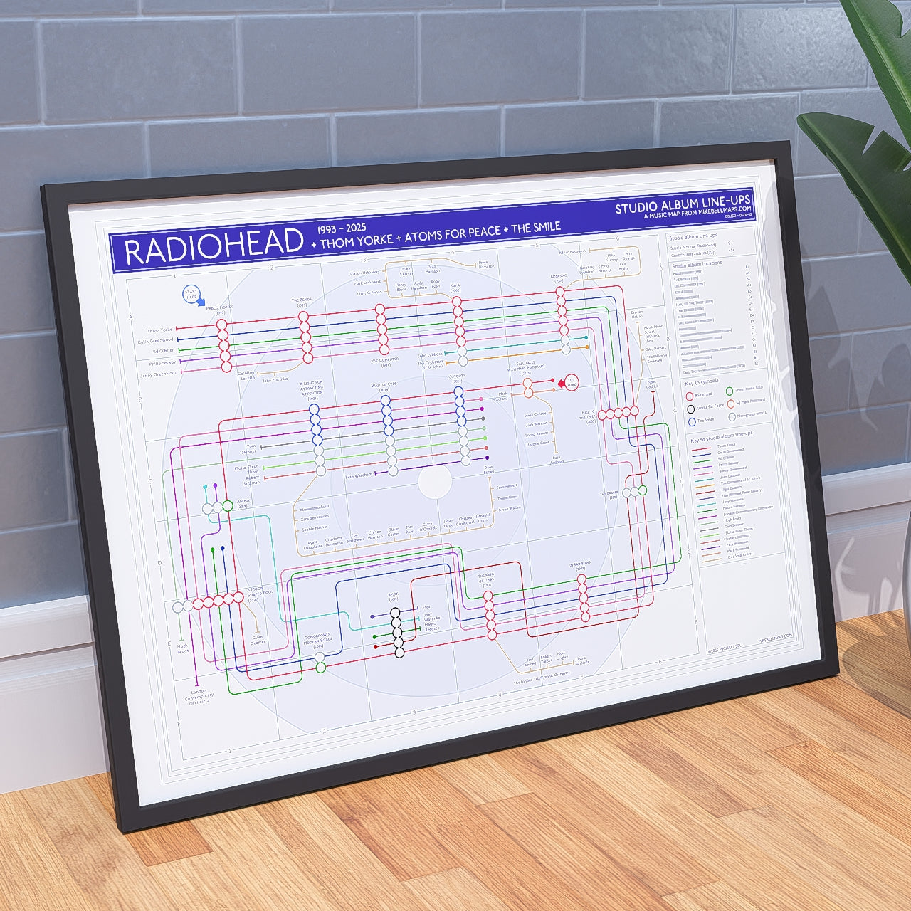 Radiohead discography tube map shown framed in A1 at an angle, Giclée wall art print on 230gsm textured matte archival fine art paper, designed by Mike Bell.
