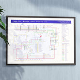 Liam Gallagher discography tube map hung in an A1 black wooden frame on a plain wall, landscape Giclée wall art print, designed by Mike Bell.