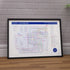 Framed Cody Johnson poster with detailed diagram on a wooden surface and tiled wall background