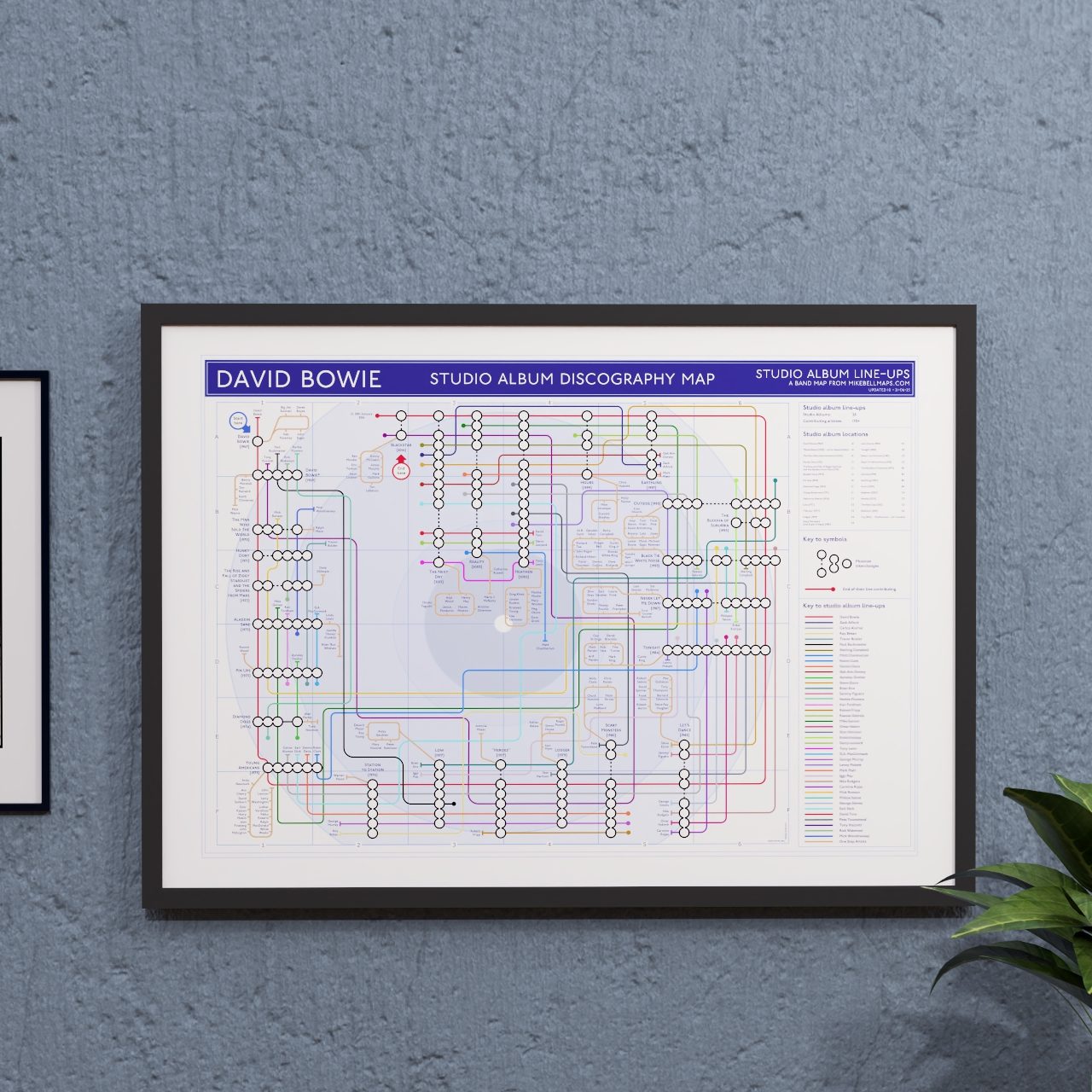 David Bowie discography tube map in A2 size, framed Giclée wall art print hung on a wall, ideal gift for Bowie fans - the same map is held in the permanent collection at the V&amp;A David Bowie Centre, V&amp;A East Storehouse, London, designed by Mike Bell.