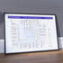 David Bowie albums in order music map in a black A1 landscape frame leaning on a wooden floor against a grey tiled wall, designed by Mike Bell at mikebellmaps.com.