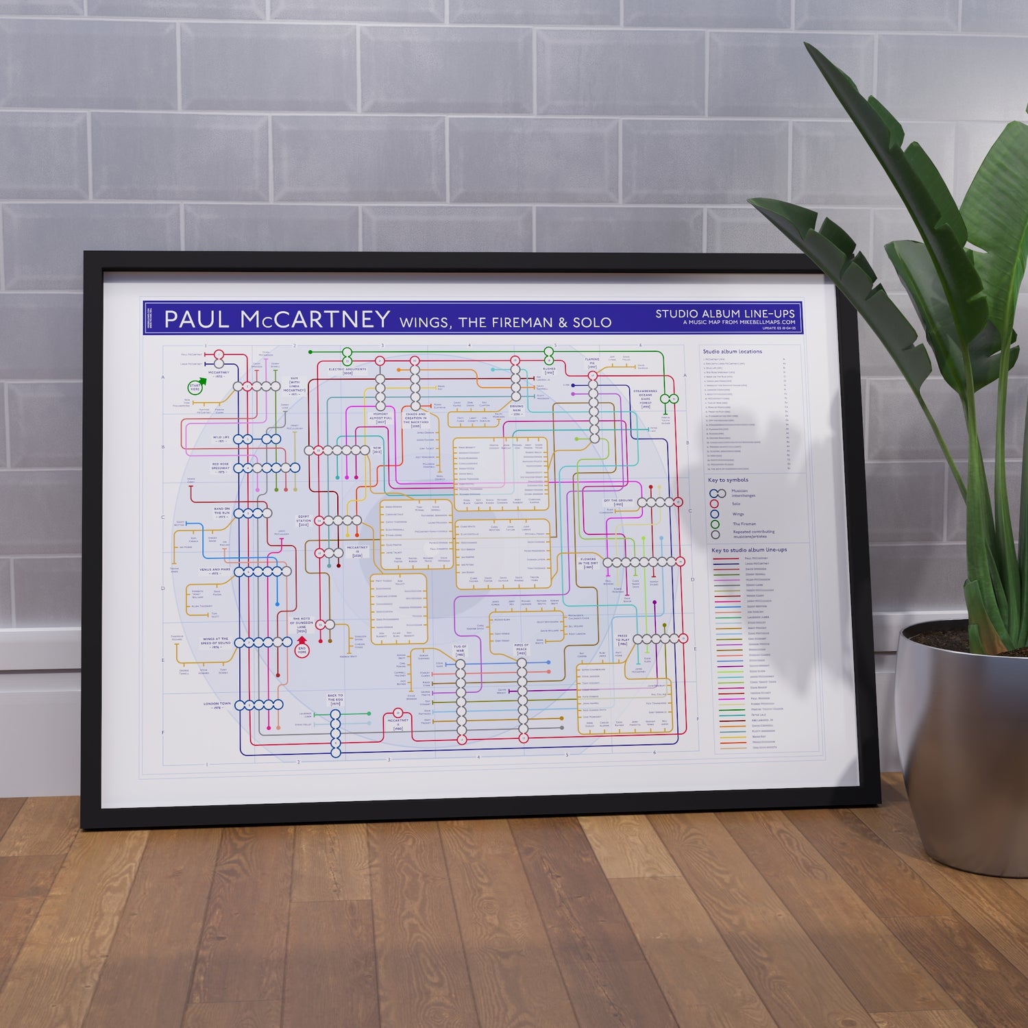 Paul McCartney discography map wall art print in a black A1 landscape frame, hung on a feature wall, showing every solo and Wings studio album in order, designed by Mike Bell at mikebellmaps.com.